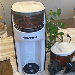 Baby Brezza  Formula Dispensers with an extra formula container and Funnel.